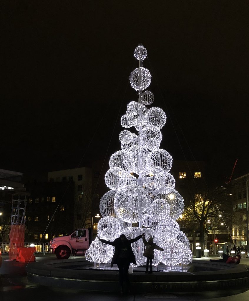 My goddaughter and I dancing around Christmas tree near the Space Needle