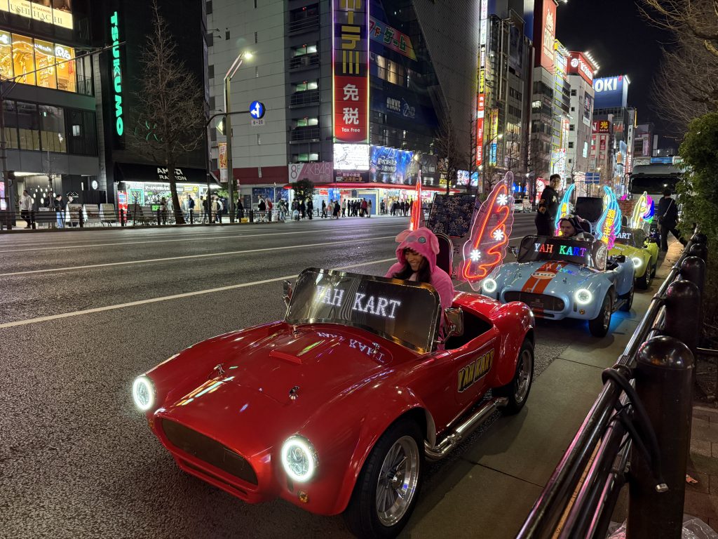 Group getting ready to go-kart through Akihabara at night