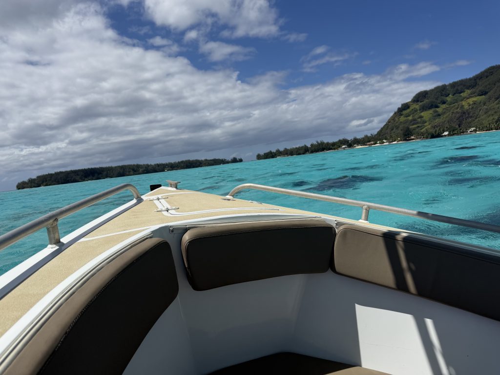 Boats head out of the lagoon to swim with whales in Moorea from July to November